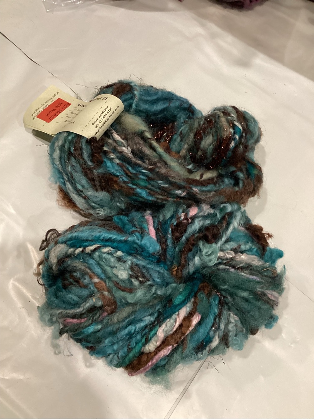 2 hanks of Ozark handspun opulence III yarn in colorway teal brook